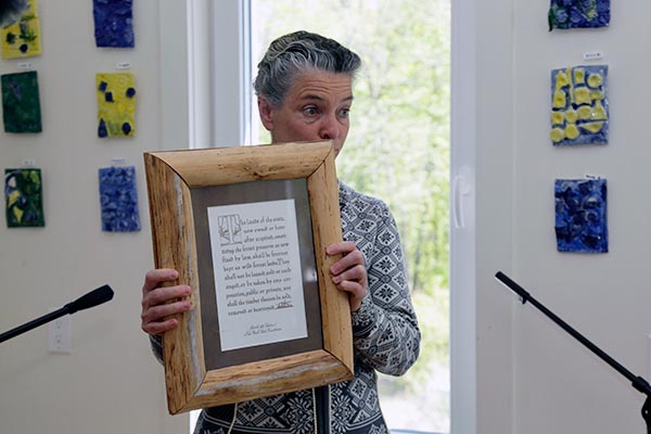 Patty Rudge shows a framed version of article 14 of the NYS Constitution